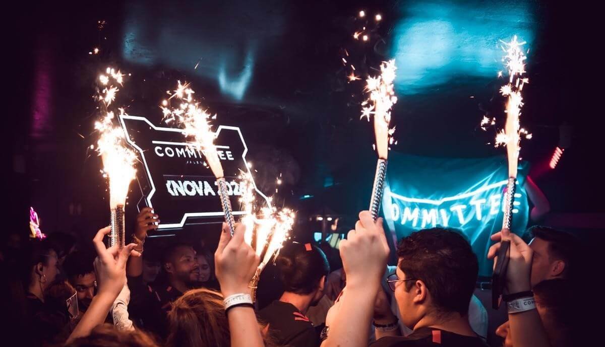 Party guests holding sparklers during a nightclub celebration in central Valencia.