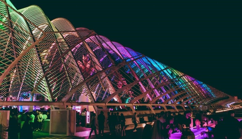Night view near Valencia’s City of Arts and Sciences with colorful lighting and modern architecture.